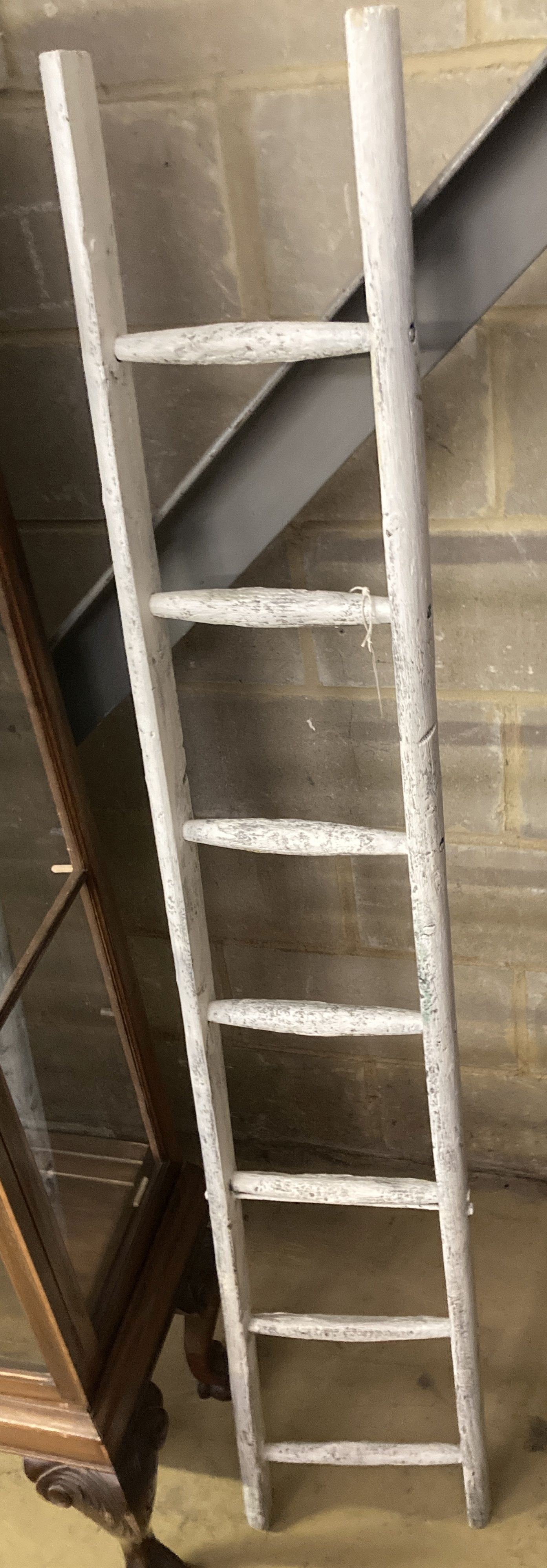 A vintage white painted wood seven tread ladder, width 30cm, height 170cm